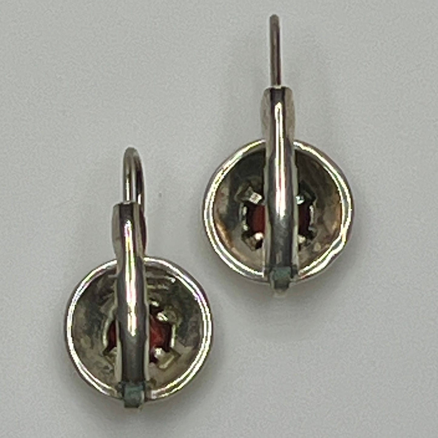 Sterling silver leverback earrings with red spinel cabochons in swirl design