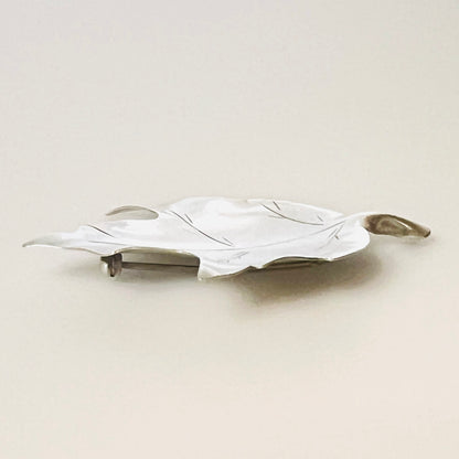 Side view of vintage Stuart Nye sterling silver maple leaf brooch and pin
