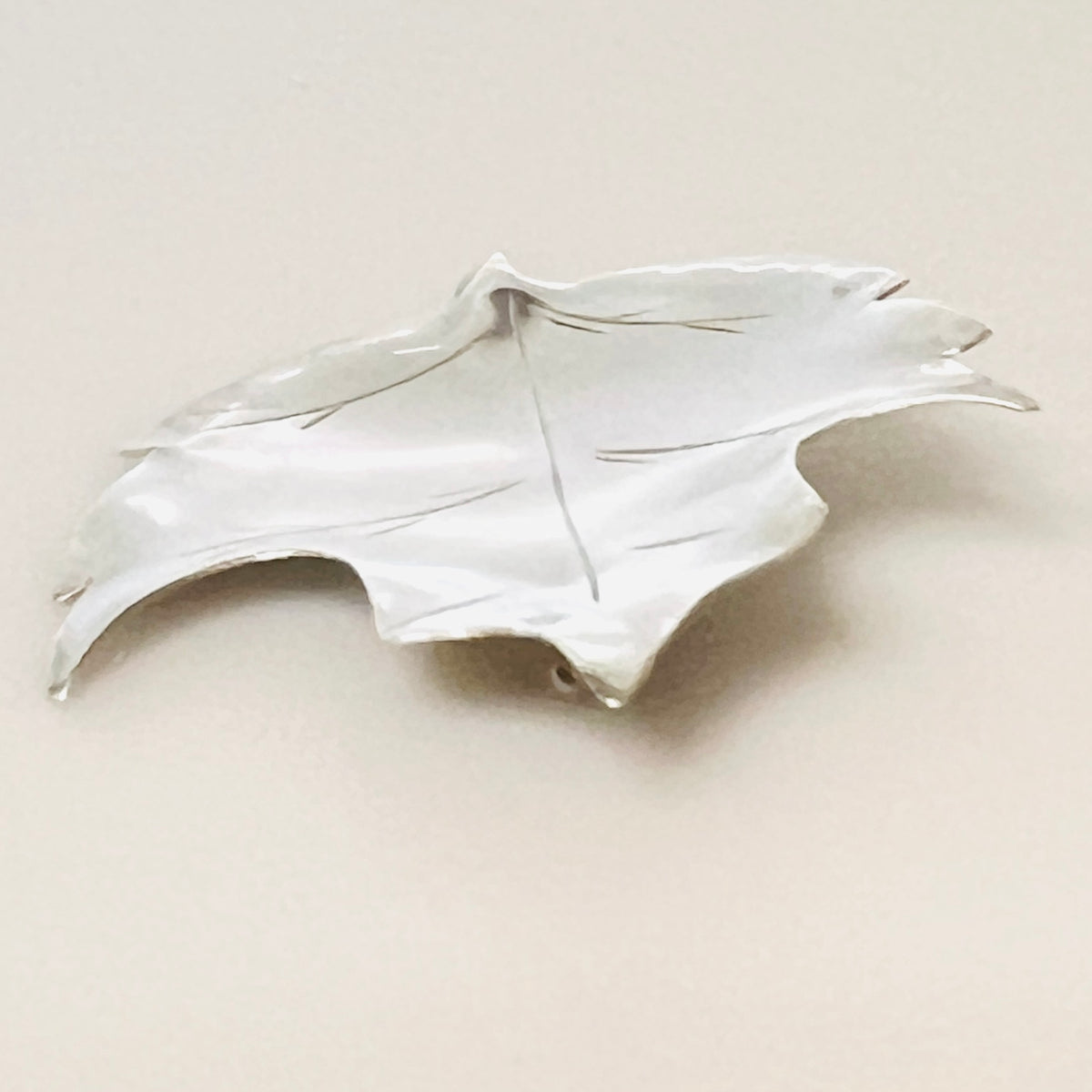 Side view of vintage Stuart Nye sterling silver maple leaf brooch and pin