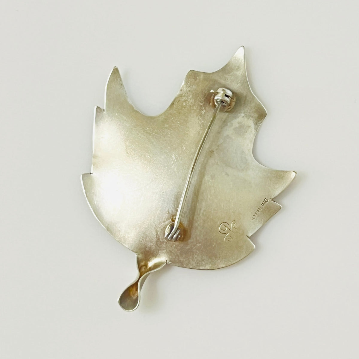Reverse of Stuart Nye sterling silver maple leaf brooch with pin closure