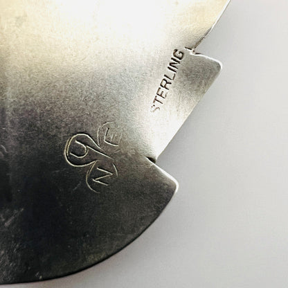 Close-up of NYE maker's mark and STERLING stamp on vintage leaf brooch