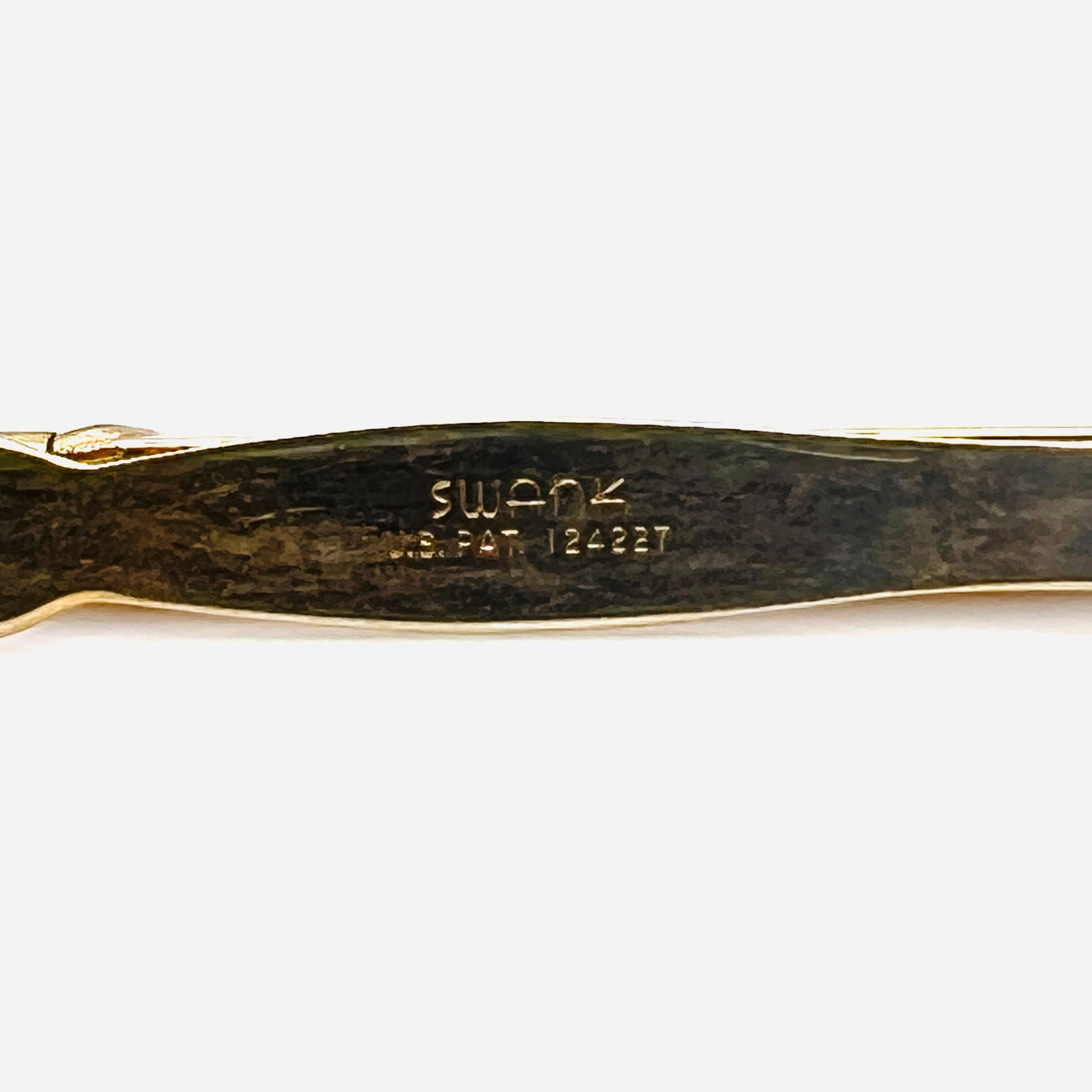 Close up of Swank signature and U.S. patent marking on vintage gold tone pencil tie clip