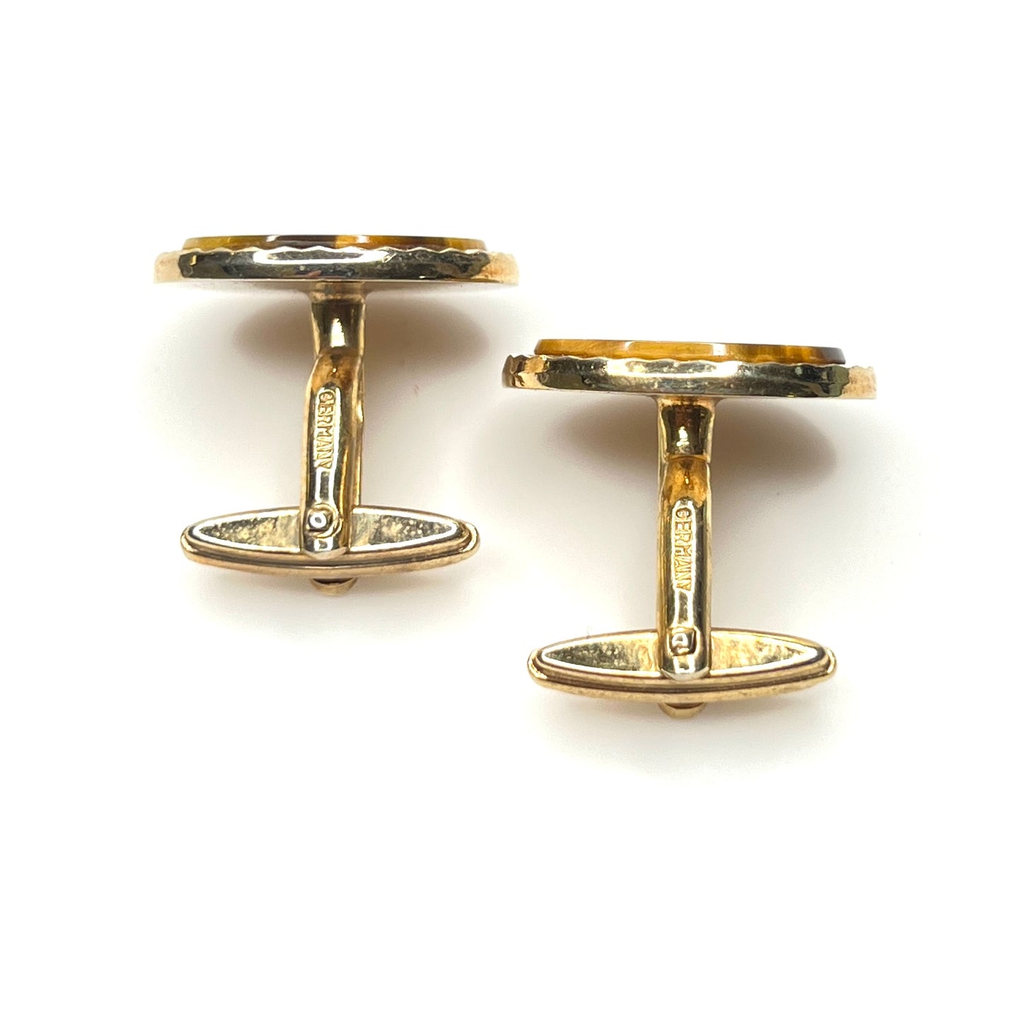 Side view of vintage tiger eye cufflinks with gold tone toggle backs