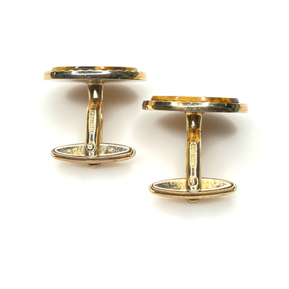 Side view of vintage tiger eye cufflinks with gold tone toggle backs