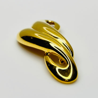 Side profile of polished gold tone abstract Trifari brooch
