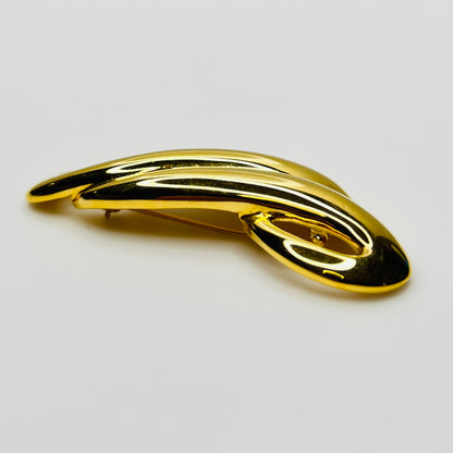 Side profile of polished gold tone abstract Trifari brooch