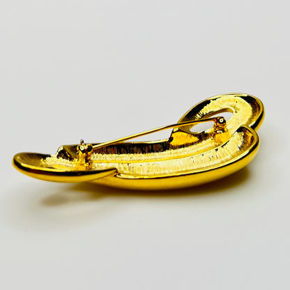 Back profile of polished gold tone abstract Trifari brooch
