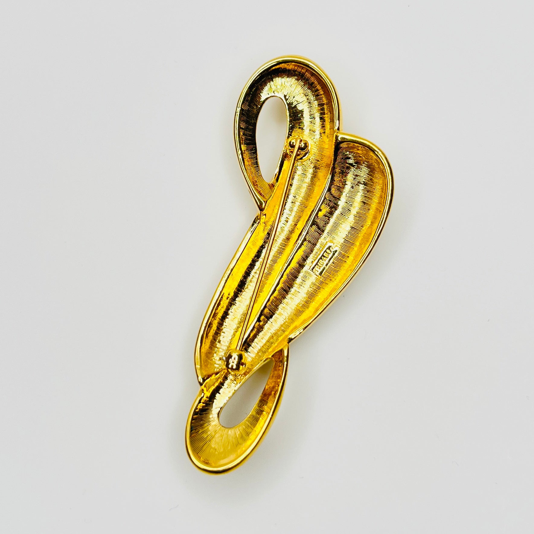 Signed Trifari TM mark on reverse of vintage gold tone brooch