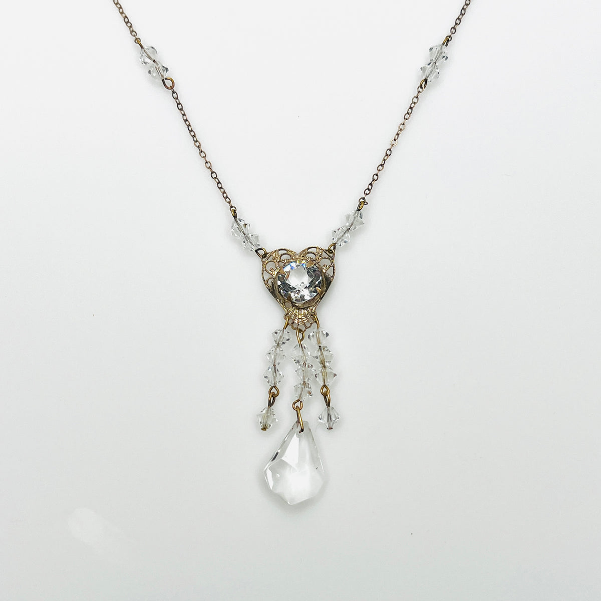 1920s crystal necklace with filigree heart centerpiece and sparkling tassel pendant