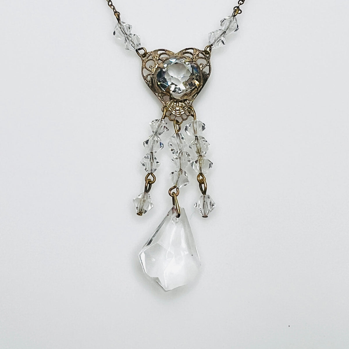 1920s crystal necklace with filigree heart centerpiece and sparkling tassel pendant