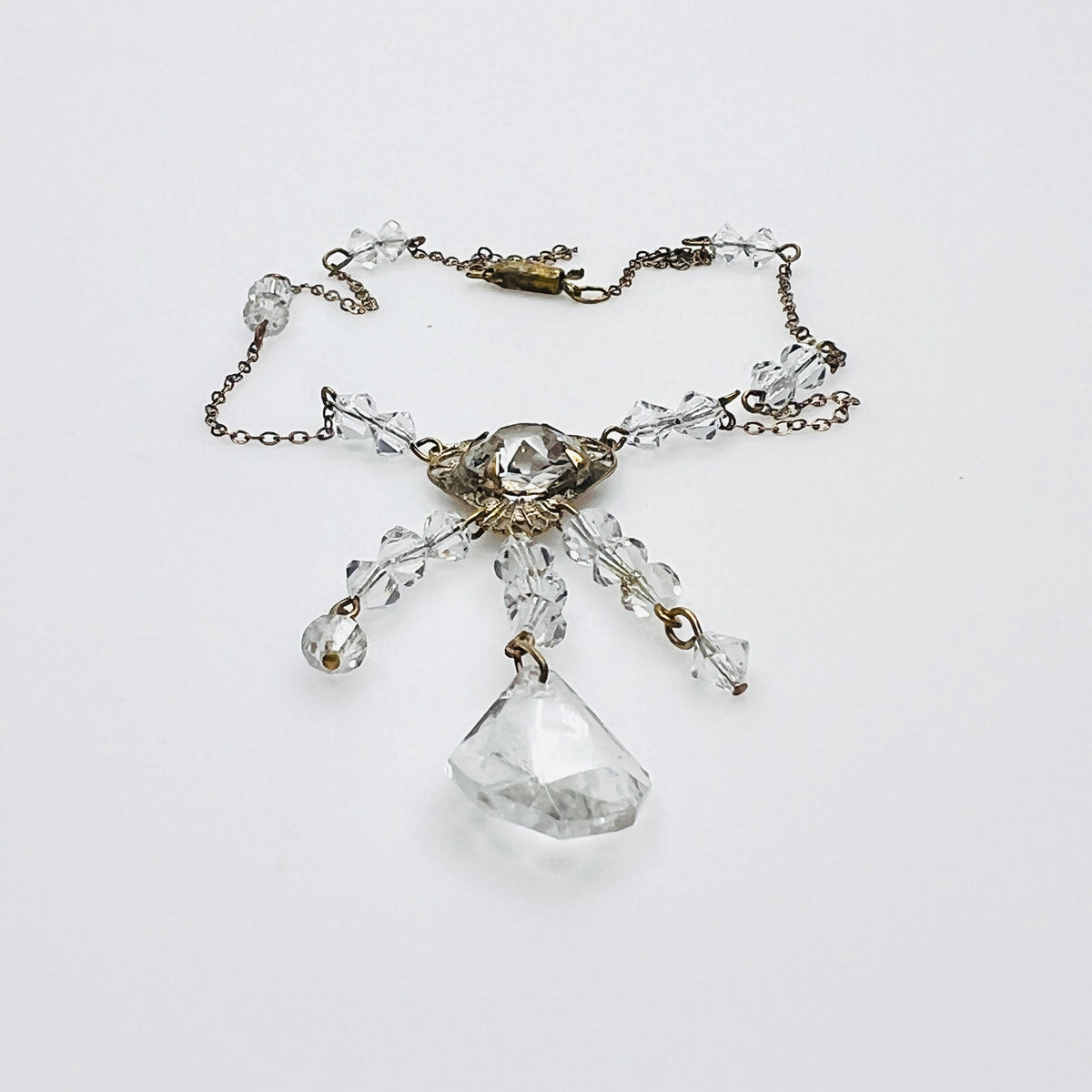 Side view of vintage crystal tassel necklace showing articulated pendant construction