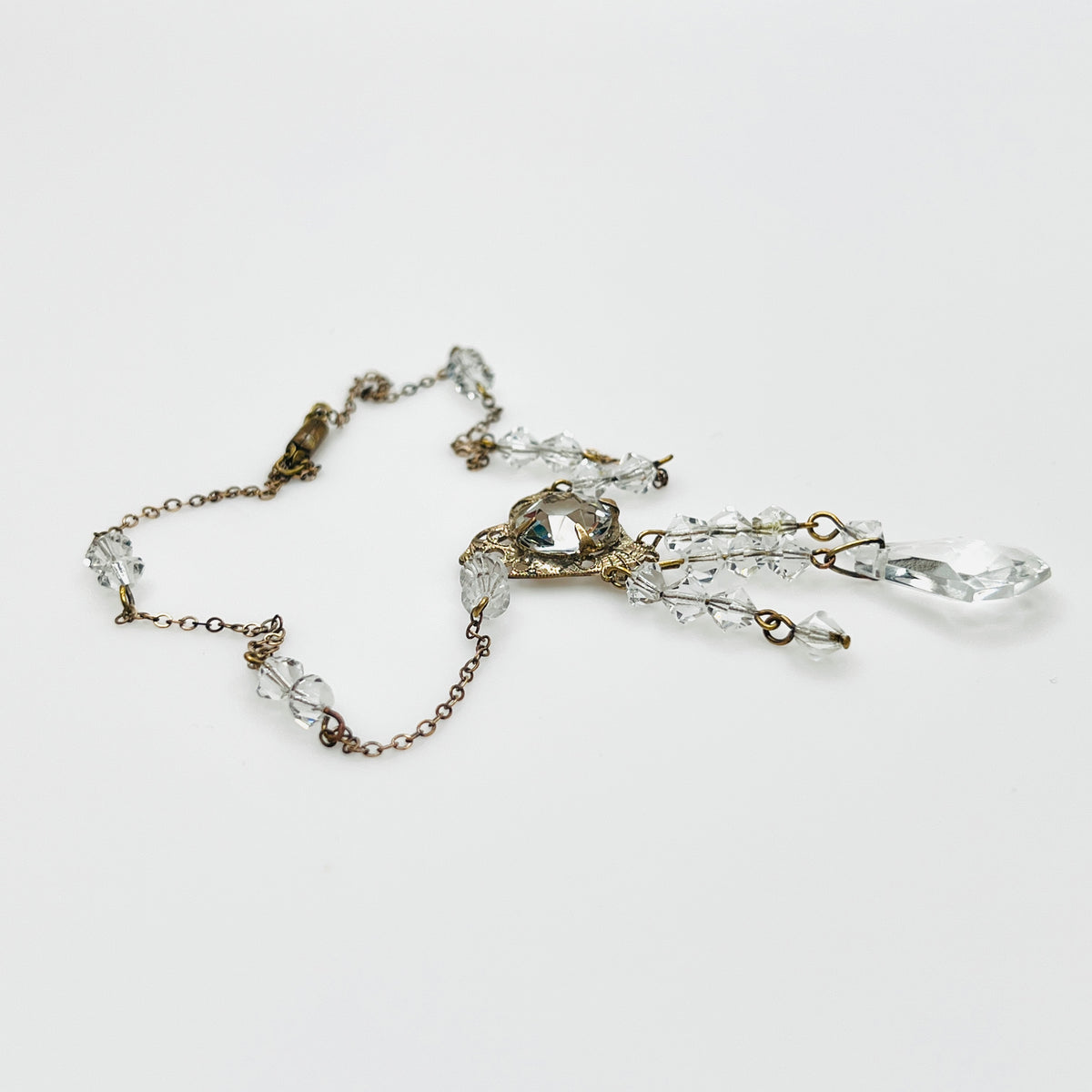 Side view of vintage crystal tassel necklace showing articulated pendant construction