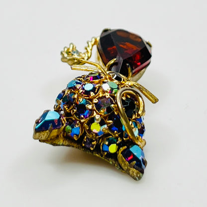 Angled view of vintage cat brooch showing gold tone finish and rhinestone details