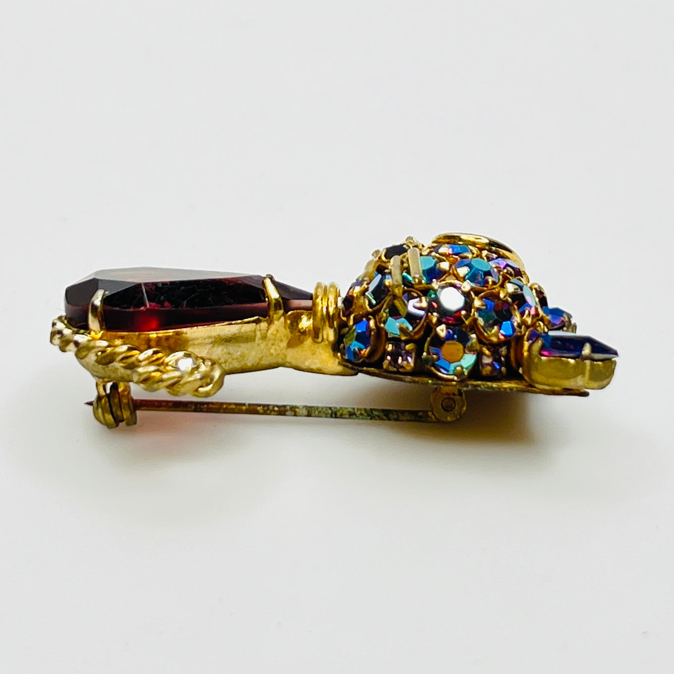 Angled view of vintage cat brooch showing gold tone finish and rhinestone details