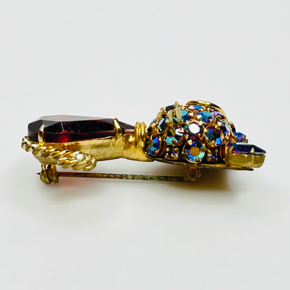 Angled view of vintage cat brooch showing gold tone finish and rhinestone details