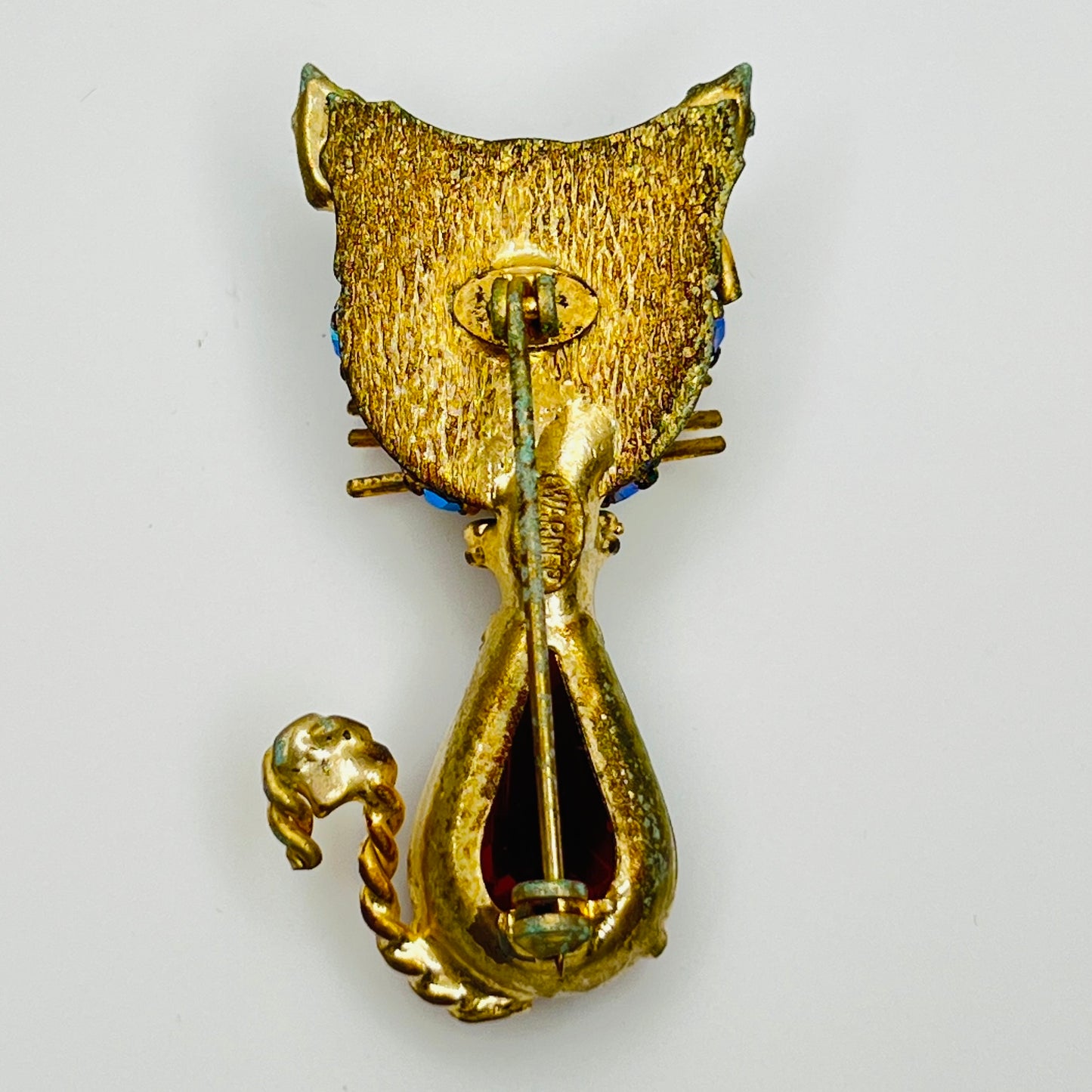 Reverse of Warner brooch with textured gold tone metal and clasp