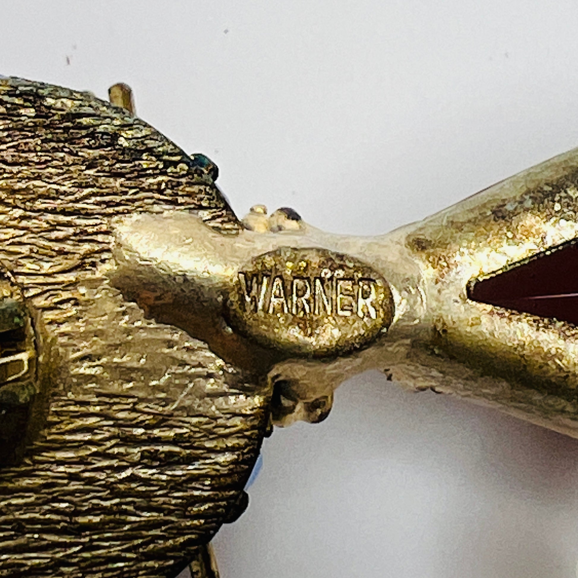 Close-up of WARNER maker’s mark on back of vintage brooch