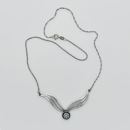 Flat lay of silver Wedgwood pendant necklace with chain
