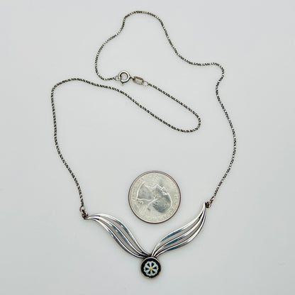 Flat lay of silver Wedgwood pendant necklace with chain