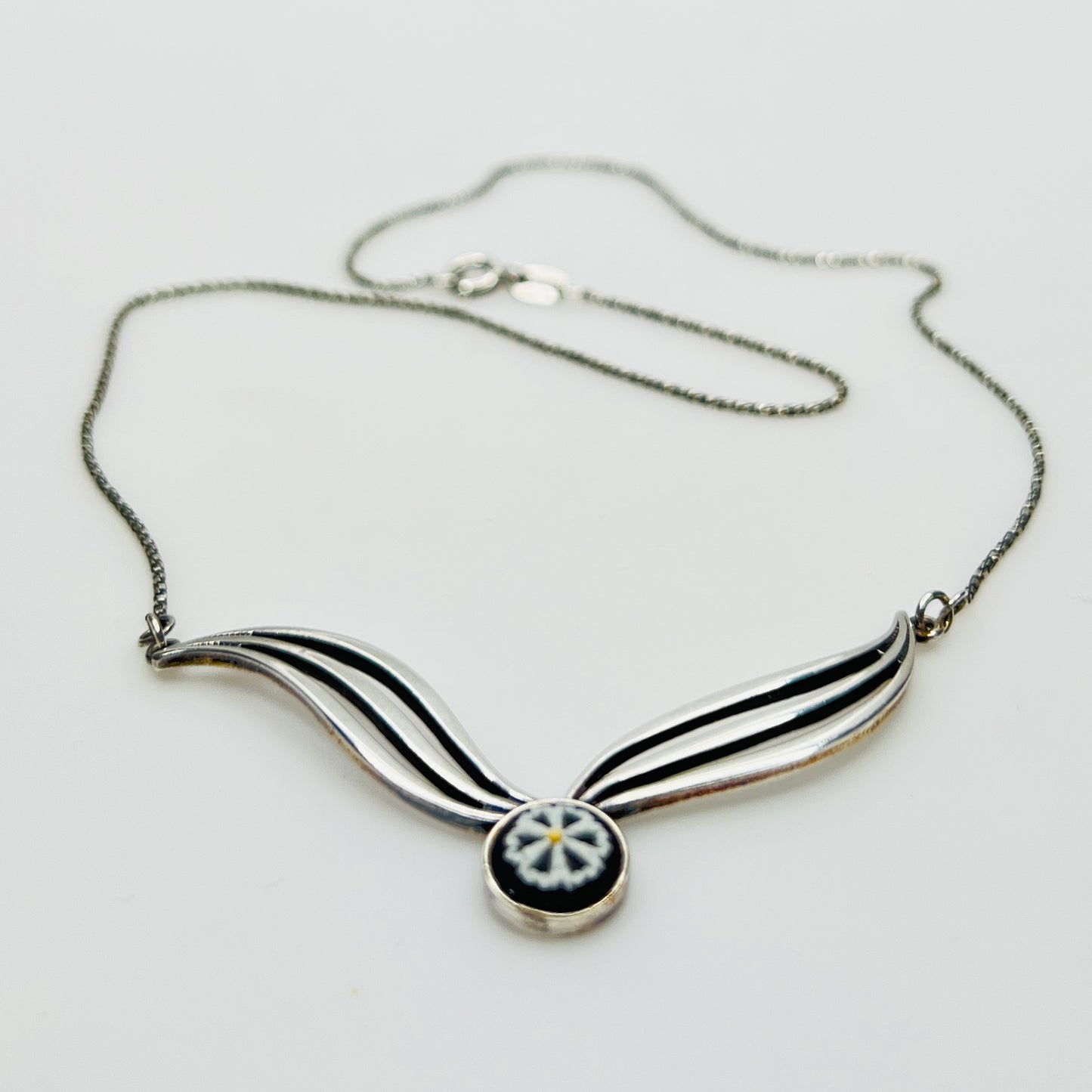 Flat lay of silver Wedgwood pendant necklace with chain