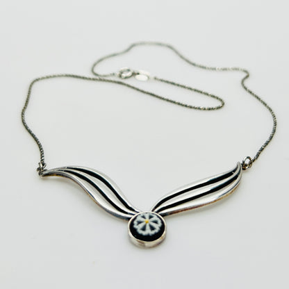 Flat lay of silver Wedgwood pendant necklace with chain
