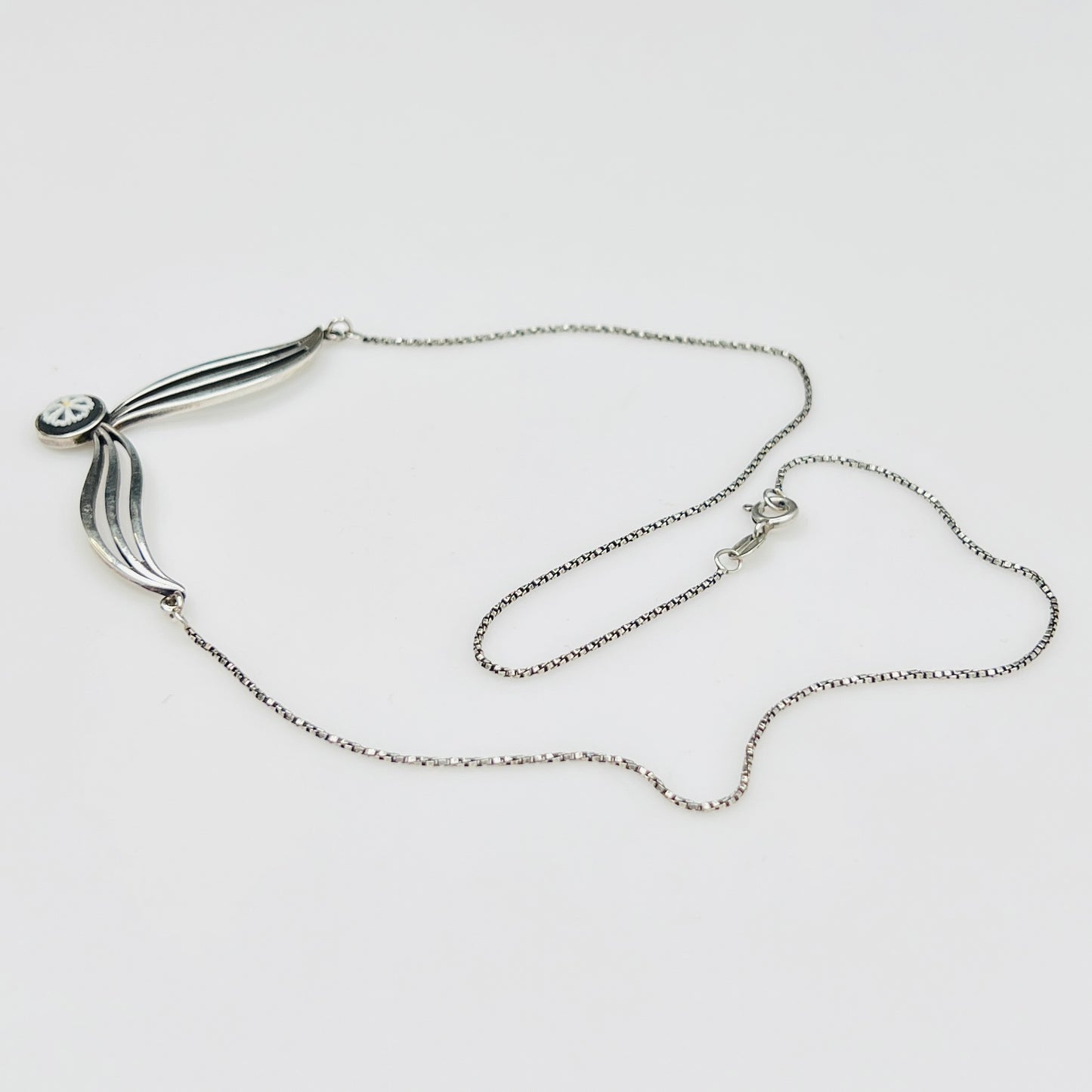 Flat lay of silver Wedgwood pendant necklace with chain