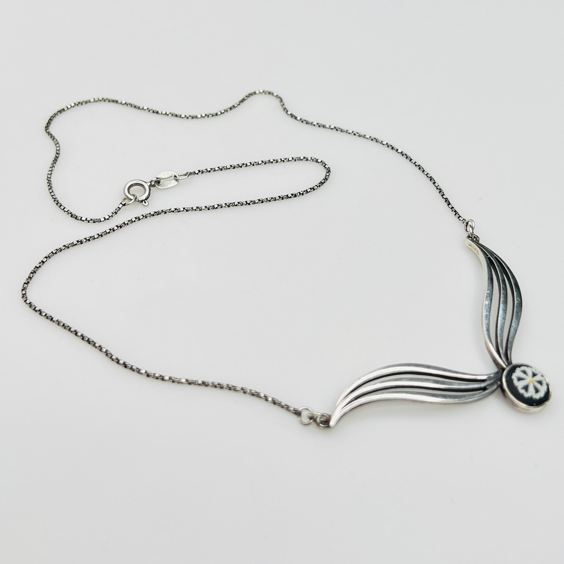 Flat lay of silver Wedgwood pendant necklace with chain