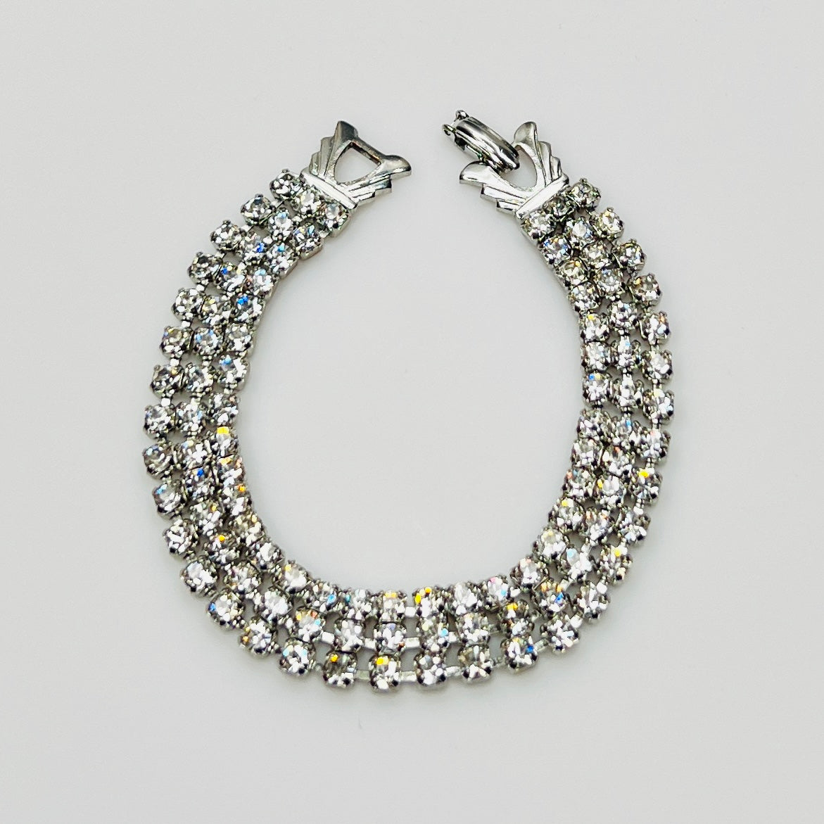 Signed Weiss triple strand clear crystal rhinestone bracelet in silver tone metal