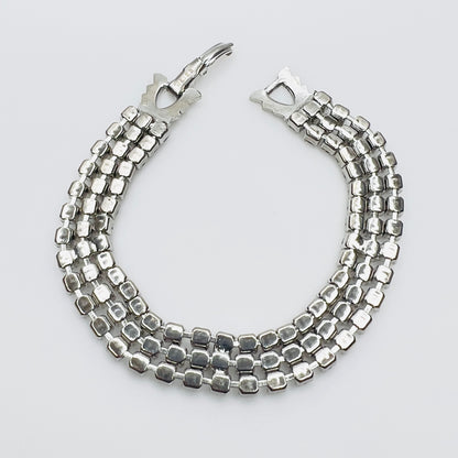 Back View Signed Weiss triple strand clear crystal rhinestone bracelet in silver tone metal