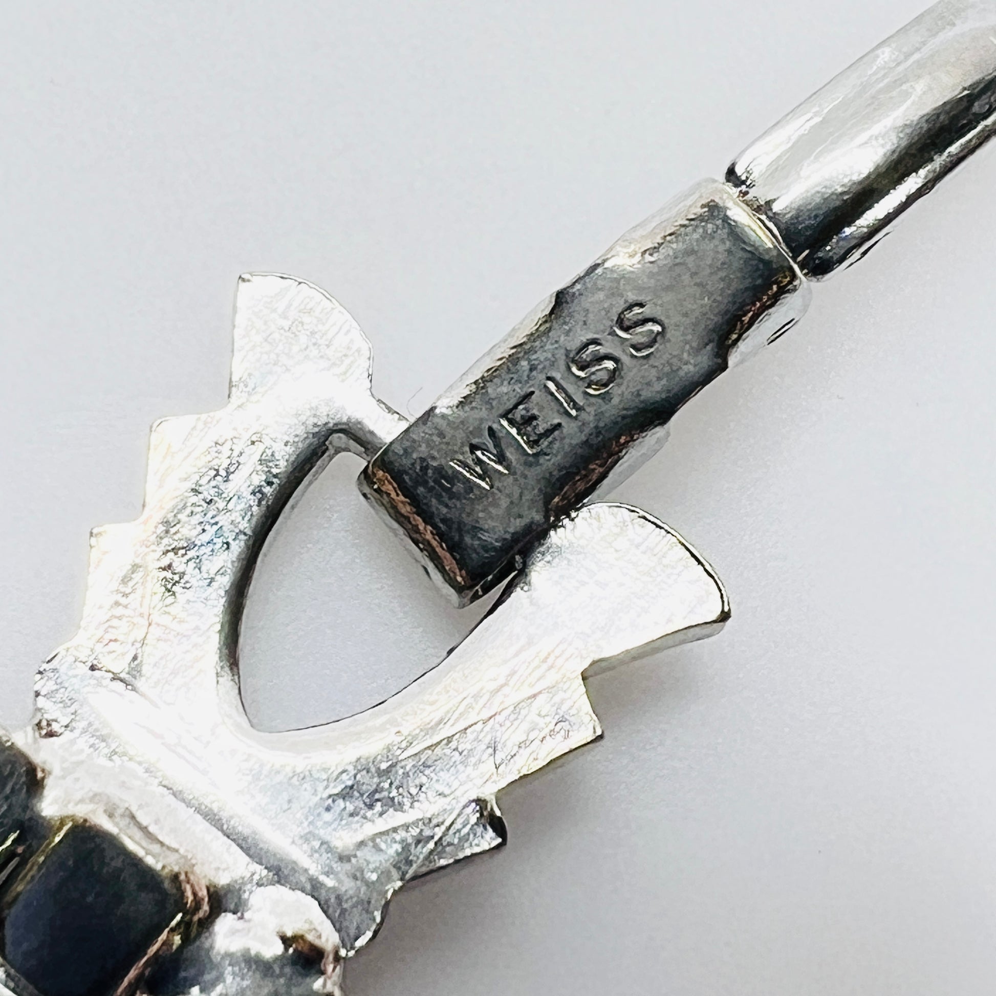 Signed Weiss clasp detail on vintage rhinestone bracelet in silver tone metal