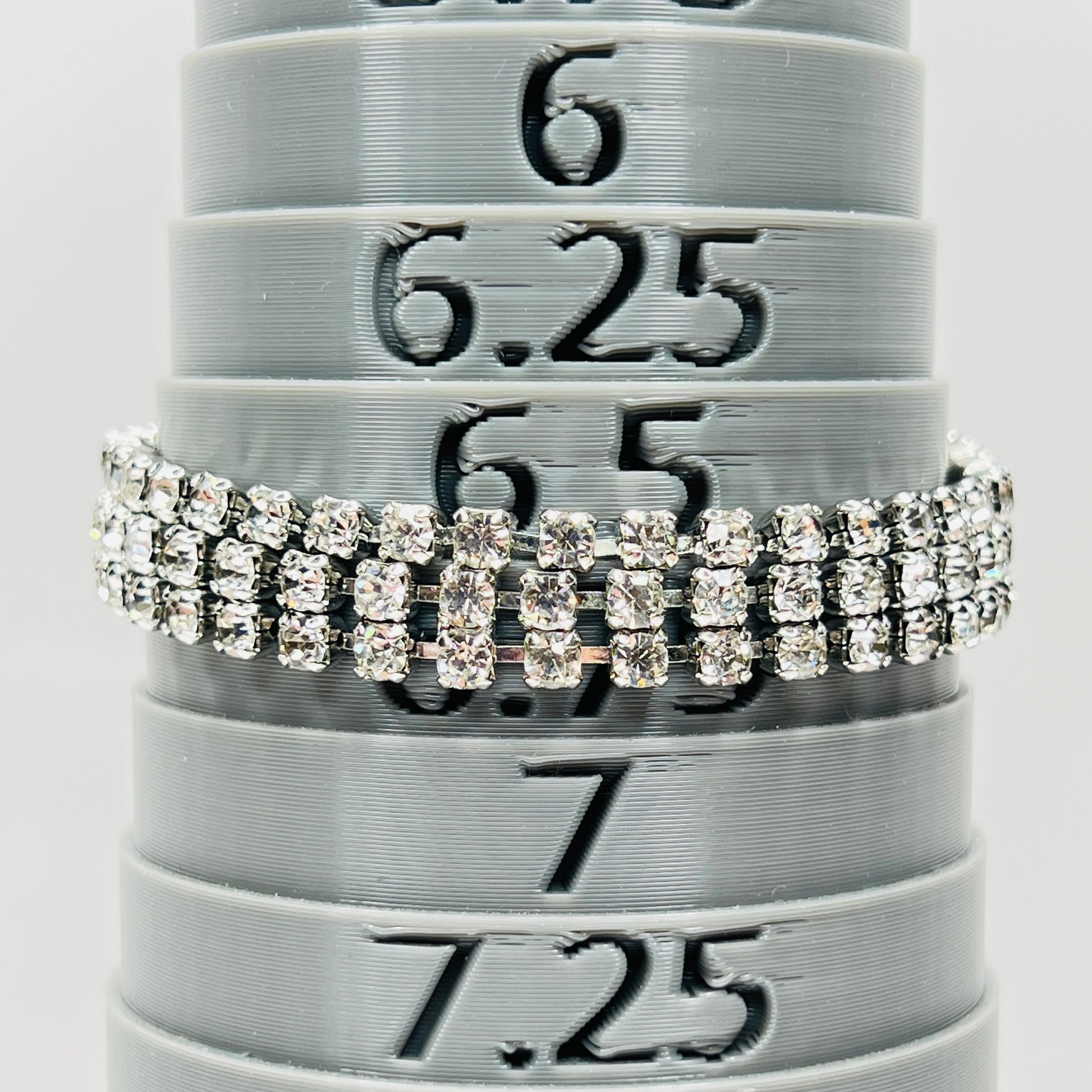 Signed Weiss triple strand clear crystal rhinestone bracelet in silver tone metal on bracelet mandrel