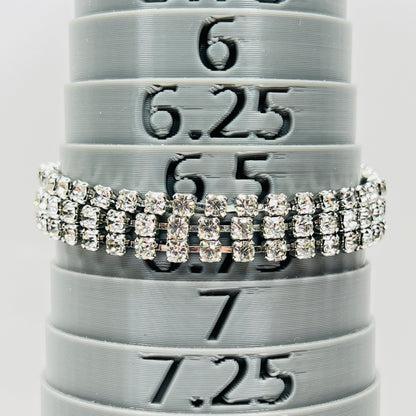 Signed Weiss triple strand clear crystal rhinestone bracelet in silver tone metal on bracelet mandrel