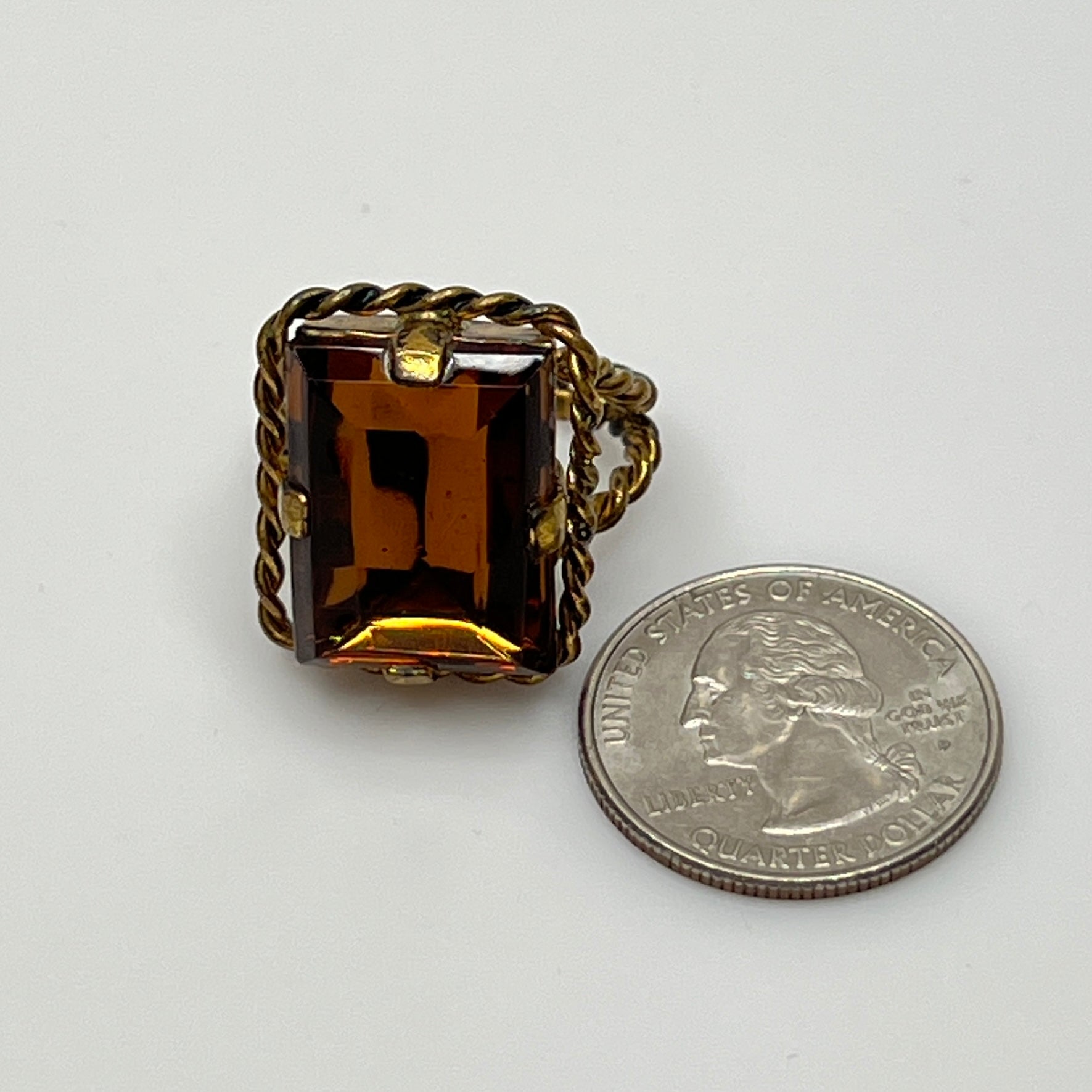 Close-up of rectangular amber stone in vintage setting