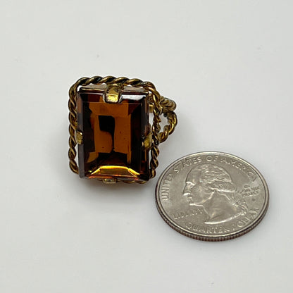 Close-up of rectangular amber stone in vintage setting